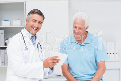 Doctor explaining prescription to senior man