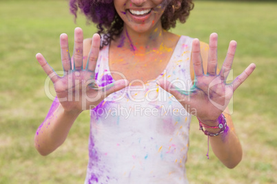 Young woman having fun with powder paint