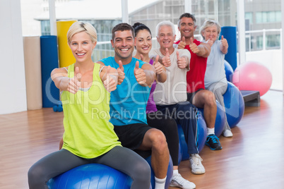 People gesturing thumbs up in health club