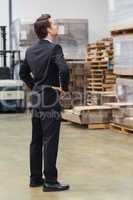 Warehouse manager standing hands on hips
