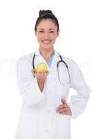 Smiling doctor offering an apple