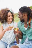 Young couple on a picnic drinking wine