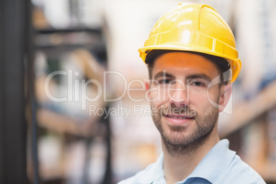 Close up of worker wearing hard hat in warehouse