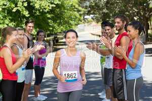 Runners applauding a racer in the park