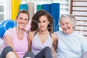 Portrait of female friends sitting in gym