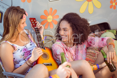 Happy hipsters relaxing on campsite