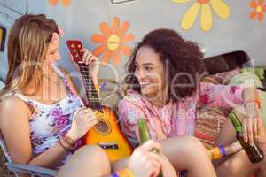 Happy hipsters relaxing on campsite