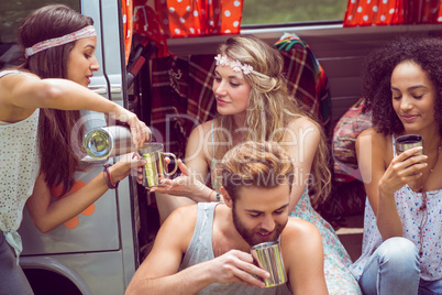 Hipster friends in camper van at festival