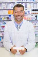 Handsome pharmacist holding medicine box