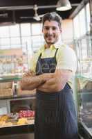 Happy server posing with arms crossed