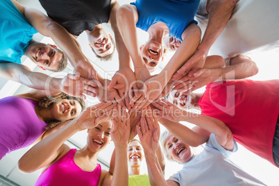 People stacking hands at health club