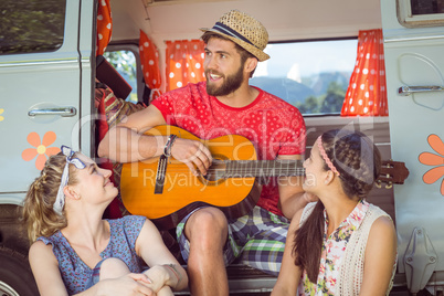 Hipster playing guitar for girls