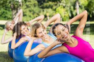 Fitness group using exercise balls in park