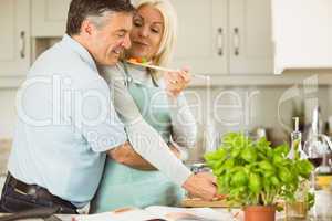 Mature couple preparing vegetarian meal together