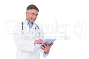 Happy doctor using tablet pc