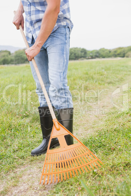 Happy man raking his farm