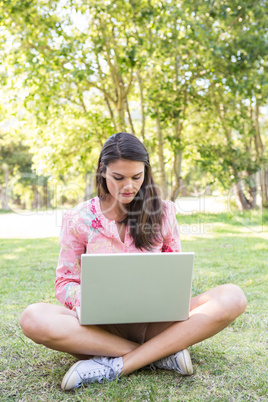 Woman using laptop in park