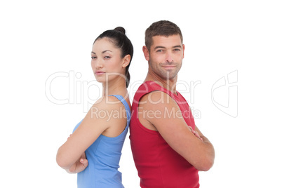 Fit man and woman smiling at camera together