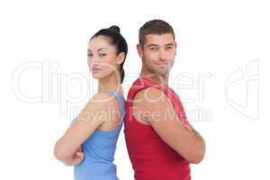 Fit man and woman smiling at camera together