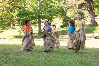 Children having a sack race in park