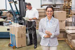 Female manager holding files during busy period