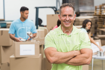 Portrait of a smiling volunteer with arms crossed