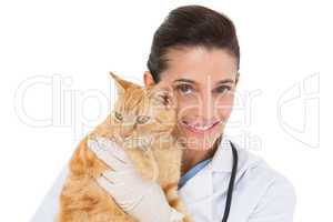 Smiling vet with a cat in her arms