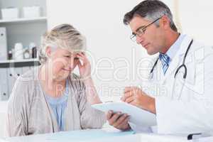 Doctor explaining prescription to senior patient