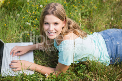 Woman using laptop in park