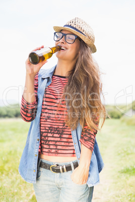 Pretty brunette in the park drinking beer