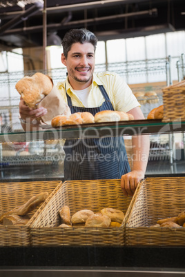 Portrait of smiling server offering bread