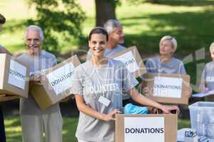 Happy volunteer brunette smiling at the camera