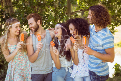 Hipster friends enjoying ice lollies