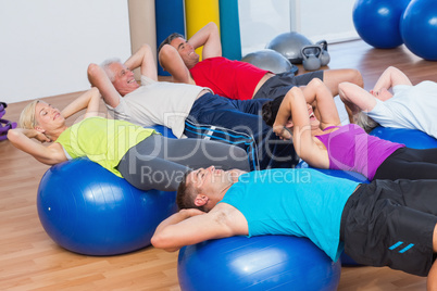 People stretching on exercise balls
