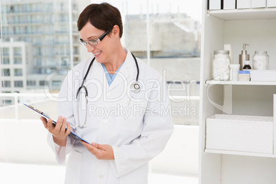 Smiling veterinarian holding clipboard