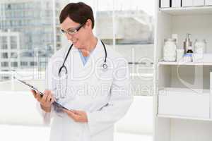 Smiling veterinarian holding clipboard