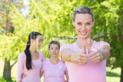 Smiling women in pink for breast cancer awareness