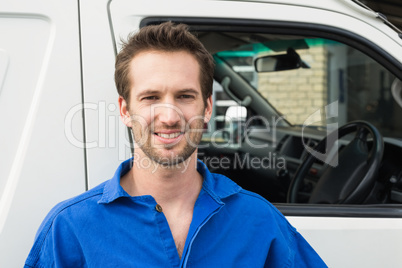 Smiling man in front of delivery van