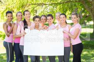 Smiling women in pink for breast cancer awareness