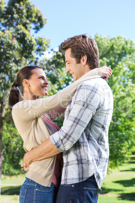 Happy couple hugging in park