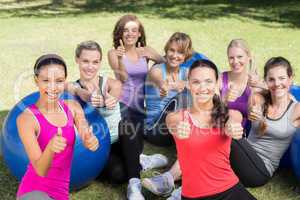 Fitness group smiling at camera in park