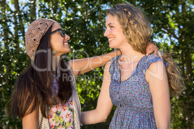 Pretty friends smiling at each other