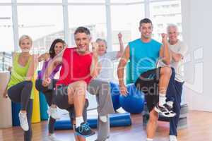 People performing aerobics exercise in gym class