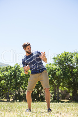 Handsome hipster playing air guitar