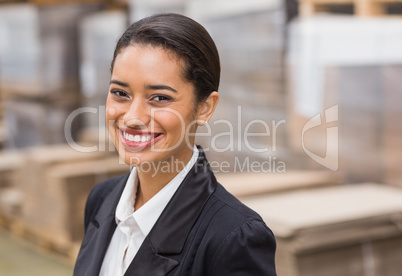 Warehouse manager smiling at camera