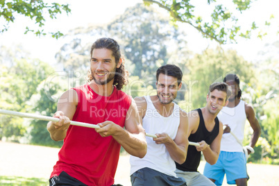 Fitness group playing tug of war Fitness group playing tug of war