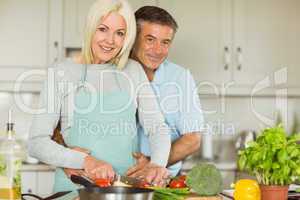 Happy mature couple making dinner together