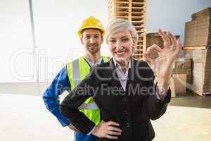 Happy businesswoman making okay gesture