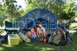 Happy family on a camping trip in their tent