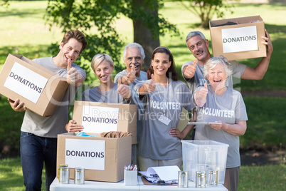 Happy volunteer family with thumbs up